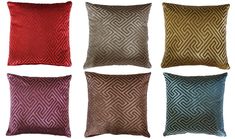 four different colored pillows on a white background