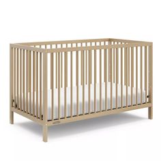 a wooden crib with white sheets on the bottom and side rails, against a white background