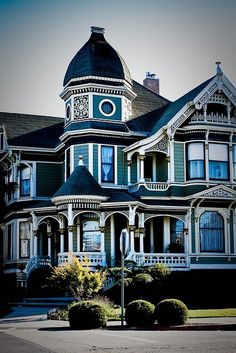 a large victorian style house with a clock on it's face