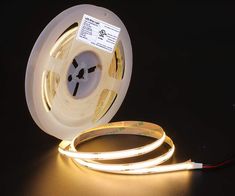 an image of a white led strip light on a black surface with the cord connected to it