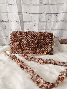 Carry a little extra sparkle wherever you go with this stunning beaded bag. Dimension: Width: 21.5cm Height: 11cm Depth: 6cm The bag comes with a detachable handle which measures 110cm. Feel free to contact me for any questions. Beaded Handheld Bags For Events, Handheld Beaded Bags For Events, Rectangular Phone Bag With Detachable Strap For Party, Handheld Beaded Event Bags, Handheld Beaded Clutch, Handheld Beaded Shoulder Bag For Events, Handheld Beaded Shoulder Bag For Party, Beaded Rectangular Phone Bag For Parties, Rectangular Beaded Phone Bag For Parties