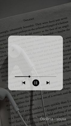 headphones are plugged into the earbuds in front of an open book