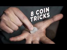 a man is pointing at a coin in the middle of his hands that says 8 coin tricks