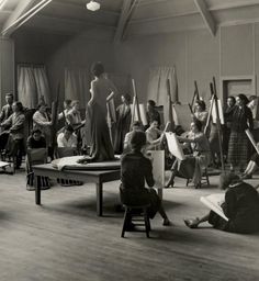 an old black and white photo of people in a room