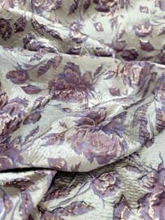 the fabric has purple flowers on it