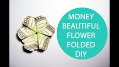 money origami flower folded up in the shape of a heart with text that reads, money beautiful flower folded diy