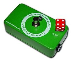 a green tin box with two red dices on the top and one white dot in the middle