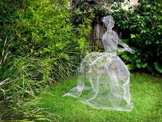 a wire sculpture in the shape of a woman