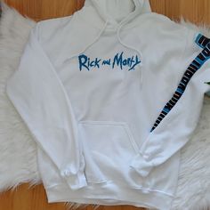 Rick And Morty White Logo Art Pullover Hoodie 210725bk 221206li White Hooded Band Merch Top, White Hooded Top With Band Merch, Custom Artwork Long Sleeve Hoodie For Streetwear, White Band Merch Hoodie Sweatshirt, White Band Merch Hoodie, Casual Hoodie With Custom Artwork For Streetwear, White Long Sleeve Hoodie With Band Merch, White Long Sleeve Hoodie Band Merch, White Band Merch Hoodie For Fall