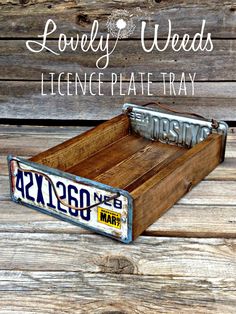 an old license plate tray with the words lovely weeds on it, sitting on a wooden surface