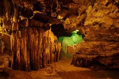 the inside of a cave with green light coming from it