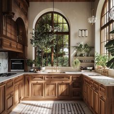 a large kitchen with wooden cabinets and marble counter tops, an arched window over the sink