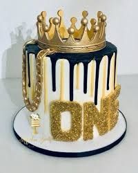 there is a cake that has been decorated with gold and black icing on it