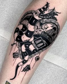 a black and white tattoo on the leg of a person with a clock in it