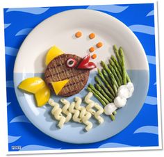 a plate that has food on it with fish, asparagus and other items