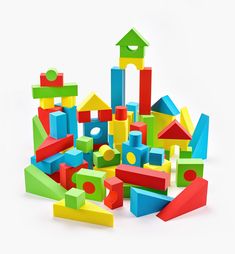 a pile of colorful wooden toys on a white background