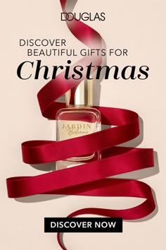 a bottle of perfume with red ribbon around it and the words, discovery beautiful gifts for christmas