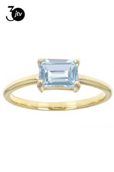 a gold ring with an aqua blue topazte in the center and two small diamonds on