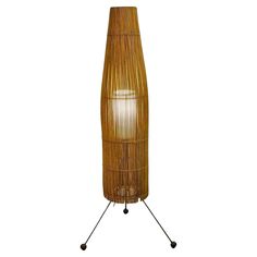 a tall bamboo floor lamp on a white background