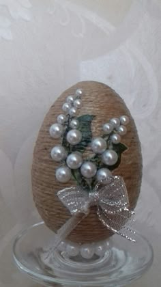 an egg decorated with pearls and a bow