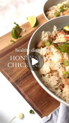 two bowls filled with rice and vegetables on top of a wooden cutting board