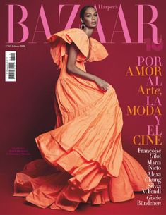 a woman in an orange dress on the cover of bazaar