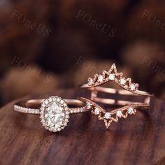 two wedding rings on top of a wooden table