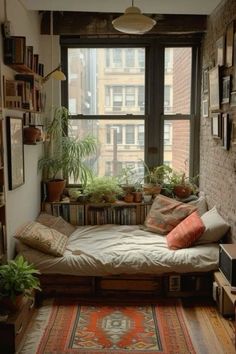 a room with a bed, bookshelf and plants on the window sill