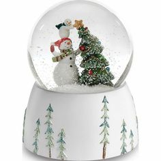 a snow globe with two snowmen and a christmas tree