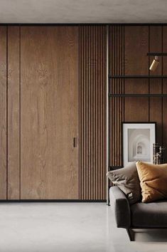 a living room filled with furniture and wooden paneling on the walls, along with a couch