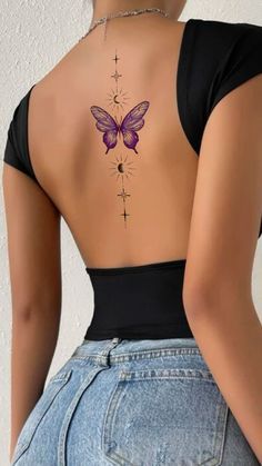 a woman with a butterfly tattoo on her back