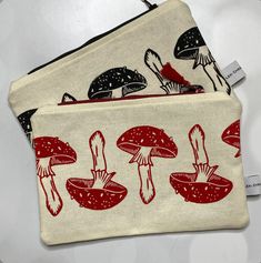 two zippered pouches with mushrooms on them