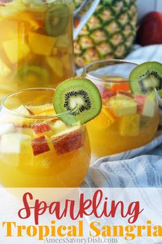 two glasses filled with tropical sangria on top of a table