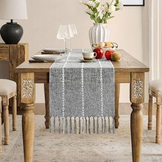 a dining room table with flowers and fruit on it