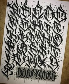 some type of calligraphy that is in black ink and white paper with the word's name written on it