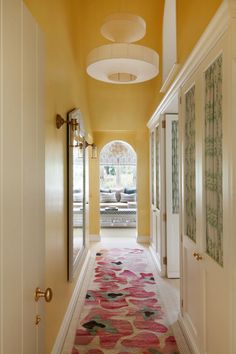 a long hallway with yellow walls and carpet