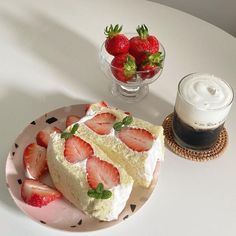 two slices of cake and some strawberries on a plate