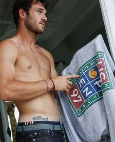 a shirtless man holding onto a towel