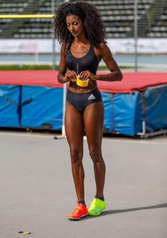 a woman in a black sports bra and neon yellow sneakers