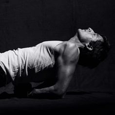 black and white photograph of a man doing push ups