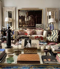 a living room filled with lots of furniture and pictures on the wall next to each other