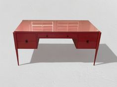 a red desk with two drawers sitting on top of it