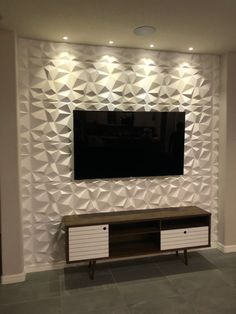 an entertainment center with a flat screen tv mounted on the wall