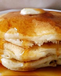 a stack of pancakes covered in butter and syrup