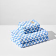 two blue and white checkered towels stacked on top of each other