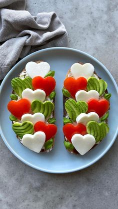 heart shaped sandwiches are arranged on a blue plate