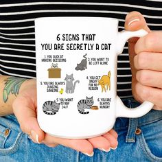 a woman holding a coffee mug with cats on it's side and the words, 6 signs that you are silently a cat