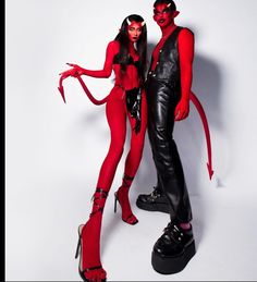 two people dressed up as devil and demongirls pose for a photo shoot in front of a white background