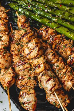 skewered chicken and asparagus on a grill