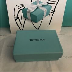 there is a blue box with a white bow on it next to a gift card